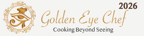 Golden Eye Chef logo in gold tones. A stylized Eye of Horus forms the central symbol, with a chef’s hat integrated above the eye. The eye is enclosed within an ornate circular floral wreath, representing creativity, inclusion, and culinary excellence beyond sight.